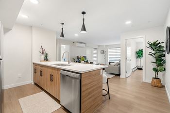 a kitchen with an island and a living room with a couch